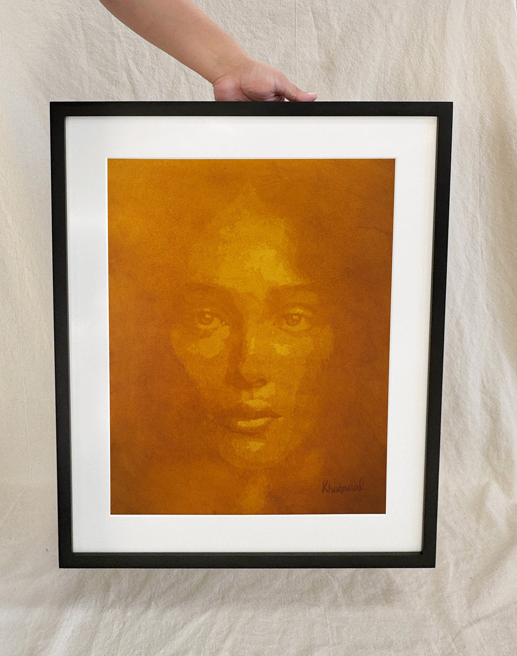 Hand shown for scale against Aziza, a 15.25 × 19.25 inch original acrylic portrait