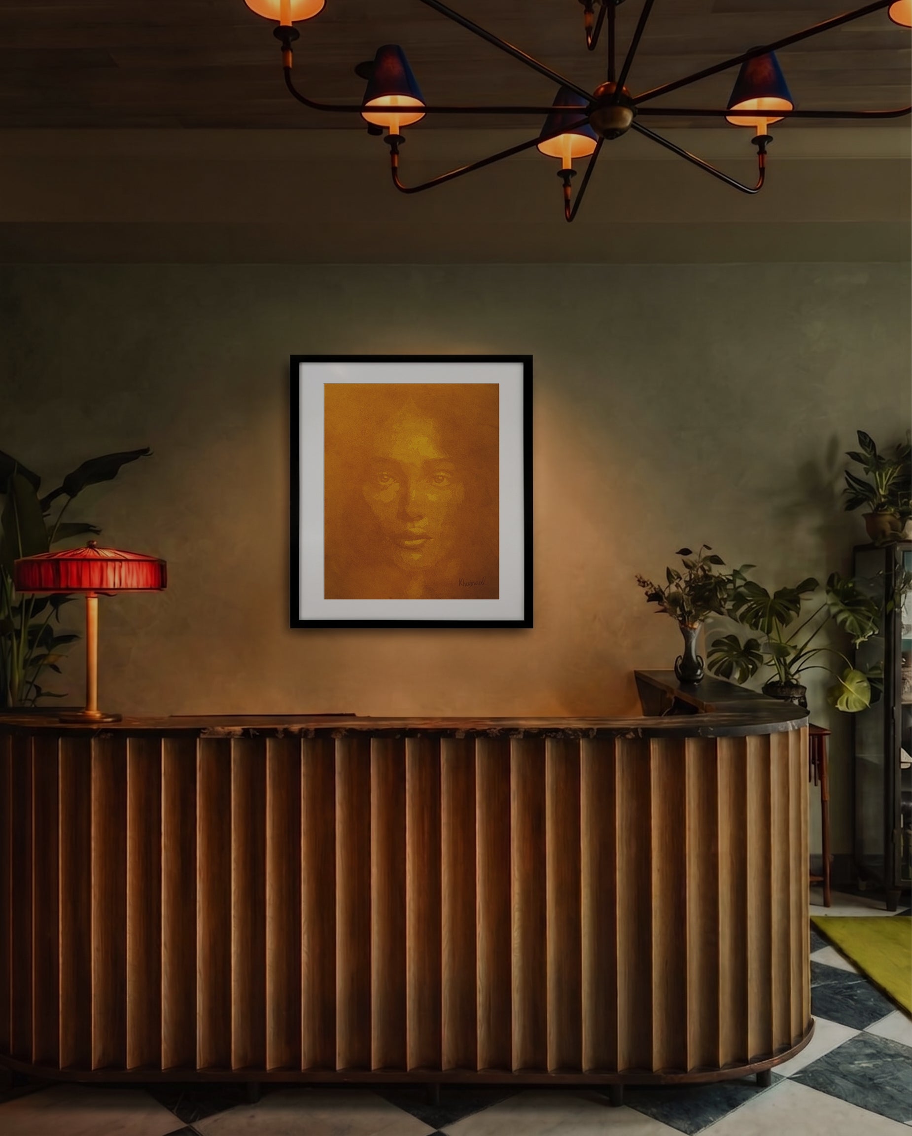 A framed art print featuring a golden-brown portrait of a face, displayed on a textured wall above a curved wooden reception desk in a warmly lit interior setting.