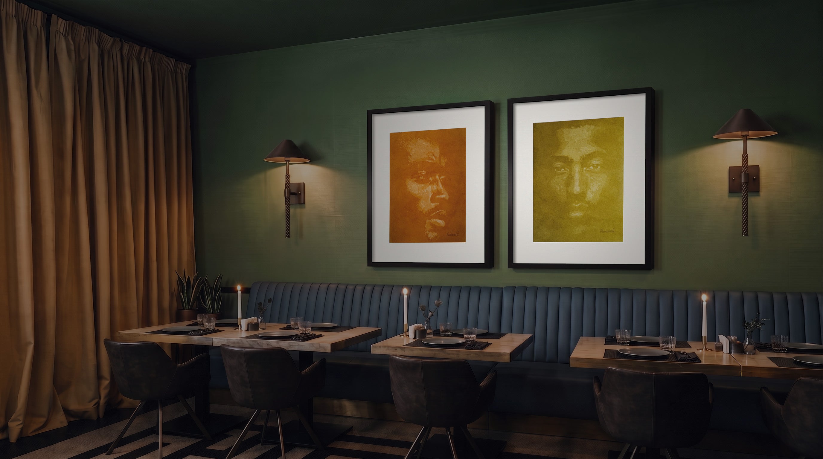 A styled dining room corner with two large framed artworks hanging on a dark green wall above a blue upholstered bench. The art feature portrait paintings in ochre and olive.